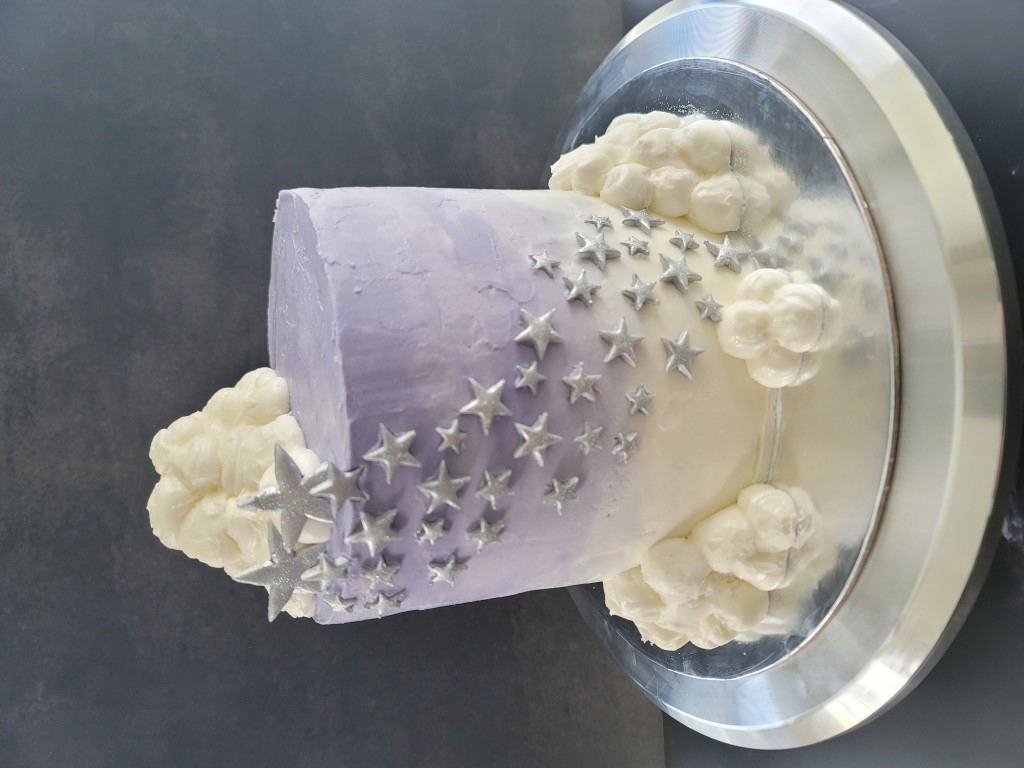 Purple ombre cake with stars and clouds